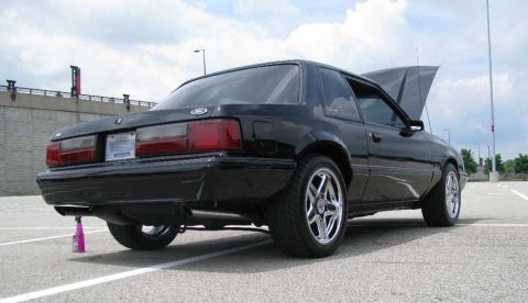 2003 Mercury Marauder - A black coupe sits in a parking lot with its hood open, viewed from the rear three-quarter angle.