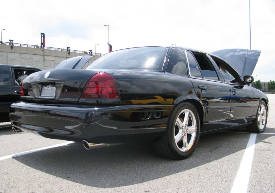 Black 2003 Mercury Marauder parked, hood open, with another car partially visible to the left