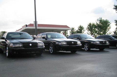 2003 Mercury Marauder - Three black 2003 Mercury Marauders are lined up in a parking lot.