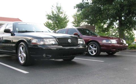 2003 Mercury Marauder - Two Mercury Marauders, one black and one maroon, are parked side-by-side.