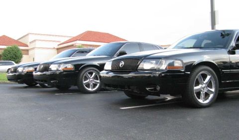 2003 Mercury Marauder - A line of black Mercury Marauders are parked side-by-side in a parking lot.
