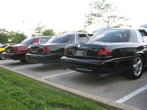 2003 Mercury Marauder - Several sedans are parked in a lot, including a black 2003 Mercury Marauder.