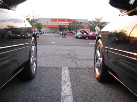 2003 Mercury Marauder - Two black cars are parked side-by-side in a parking lot with a Home Depot in the background.