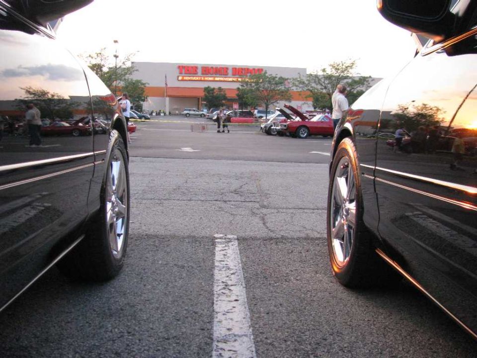 Black 2003 Mercury Marauder parked next to another car, side view, chrome wheels, sunset reflection