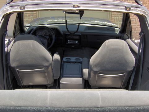 1987 Ford Bronco - The interior of an SUV is shown, focusing on the front seats and dashboard area.