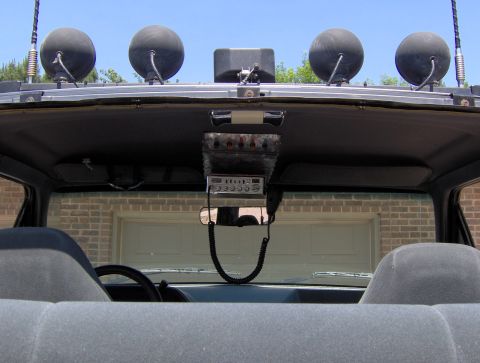 1987 Ford Bronco - Interior view of a vehicle showing a CB radio and auxiliary lights on the headliner.