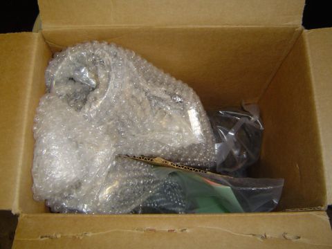 1978 Ford Bronco - A new exhaust pipe is packaged in bubble wrap and placed inside a shipping box.