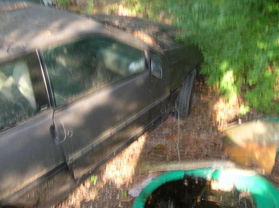1990 Ford Probe 3q-front view of a dark coupe with a black roof