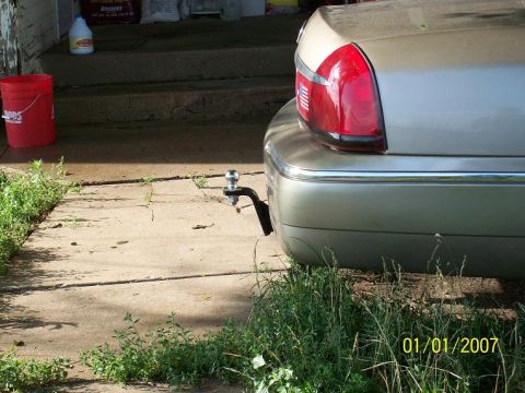 2000 Mercury Grand Marquis - Rear view of a tan sedan, a trailer hitch and a date stamp of 01/01/2007.