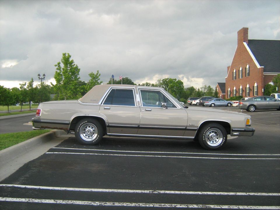 Side profile of a tan Ford LTD Crown Victoria or Mercury sedan