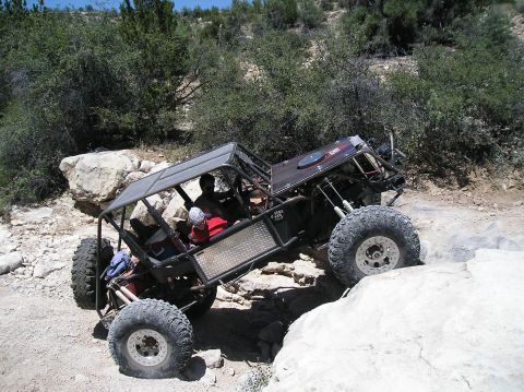 1986 Toyota Hilux - A custom-built buggy navigates a rocky trail, demonstrating its off-road capabilities.