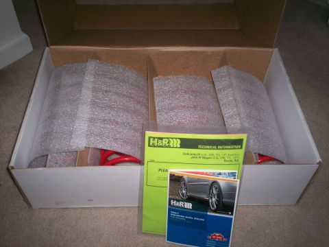1993 Ford Probe - H&R suspension parts, including springs and wheel spacers, are shown packaged in a box with documentation.