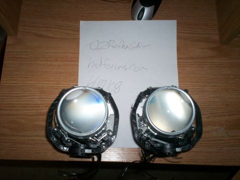 1993 Ford Probe - Two projector headlights are shown on a wooden table next to a handwritten note.