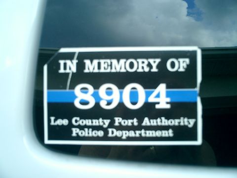 2008 Ford Escape - A memorial decal is affixed to the window of a white vehicle.
