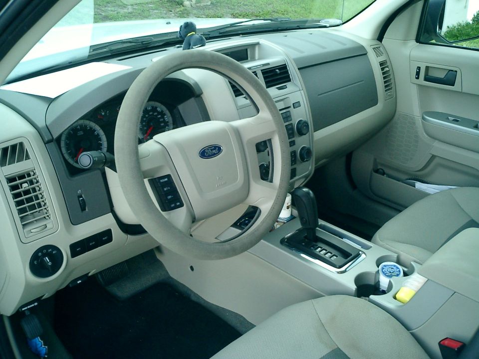 Tan Ford SUV interior with Ford steering wheel, gauges and console shifter
