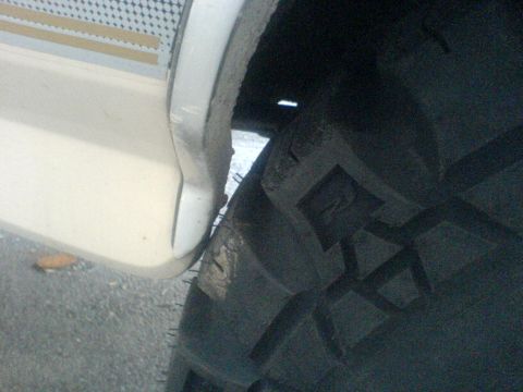 1985 Ford Bronco - A close-up view shows a tire and fender flare, with a textured decal on the flare.