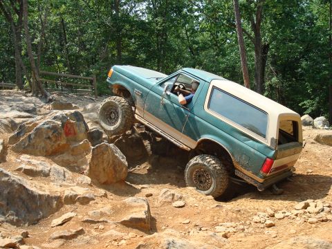 1990 Ford Bronco - This modified Ford Bronco navigates a challenging rocky terrain on an off-road course.