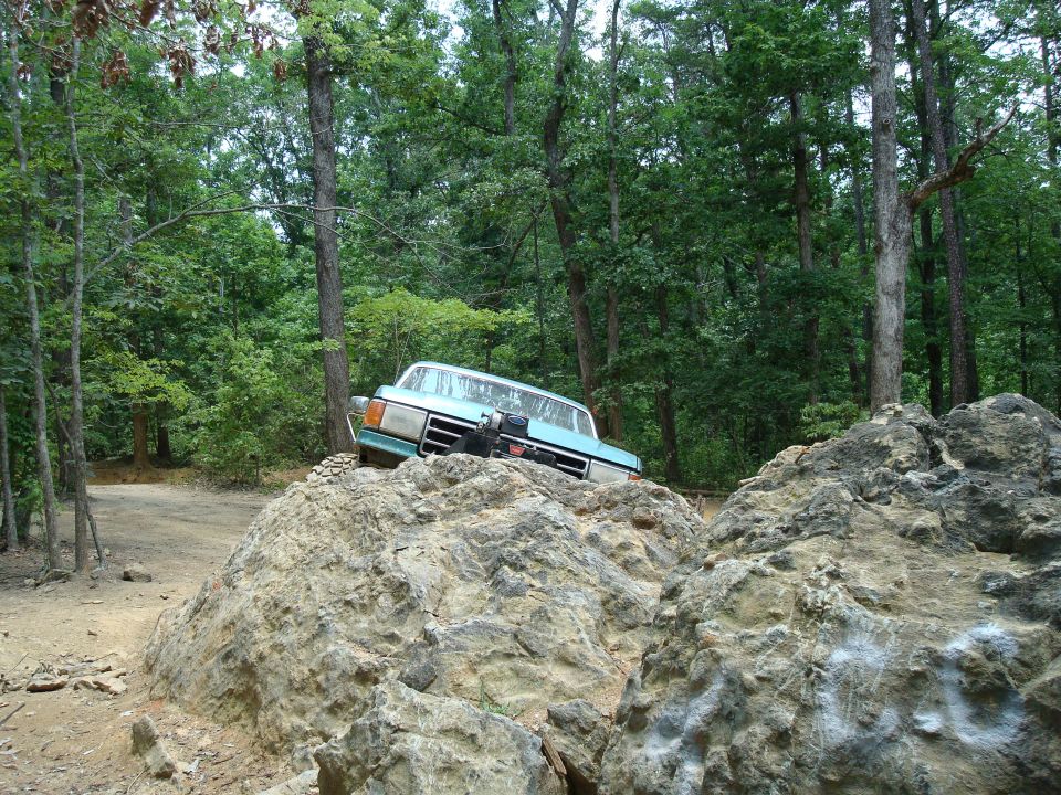 1990 Ford Bronco navigating rocks on a trail