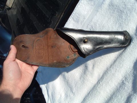 1995 Mercury Grand Marquis - A person is holding a worn leather gun holster over a white towel.