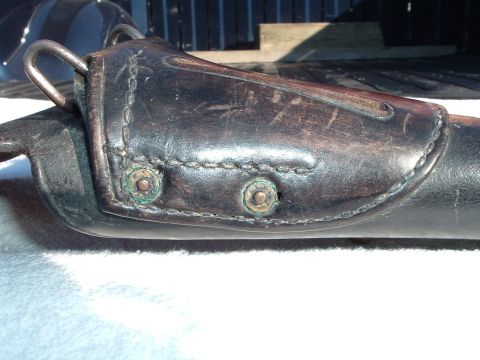 1995 Mercury Grand Marquis - A close-up view of a worn leather holster with visible stitching and metal hardware.