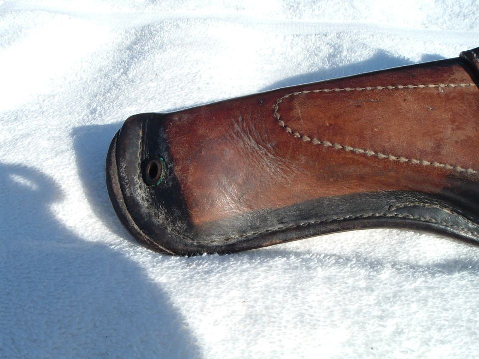 Brown leather gun holster with black trim and visible stitching