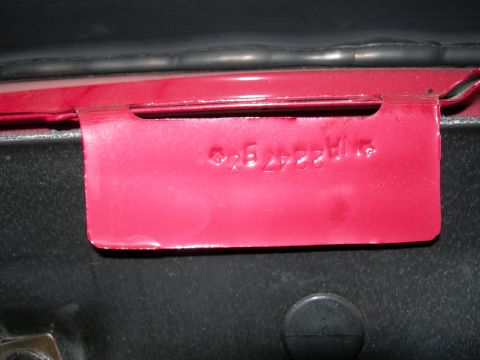 1992 Ford Taurus - A red metal plate with stamped identification numbers is visible, likely a vehicle's VIN.