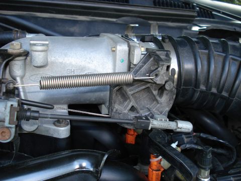 2000 Ford Crown Victoria - Close-up view of a Ford throttle body and air intake system components.