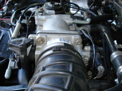 2000 Ford Crown Victoria - Close-up view of an engine's throttle body, a barcode label.