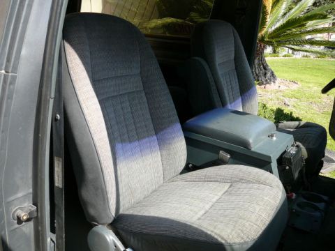 1988 Ford Bronco - The interior of this 1988 Ford Bronco features cloth bucket seats and a large center console.