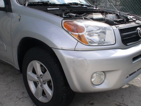 1993 Ford C-350 (Centurion Conversions) - Front view of a silver Toyota RAV4 with the hood open, showing the engine compartment.