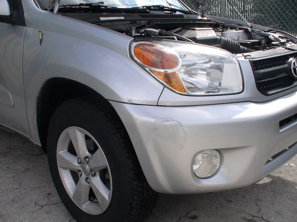 Silver Toyota RAV4 front fender and bumper with hood open