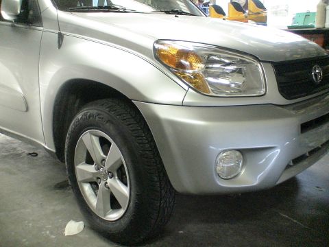 1993 Ford C-350 (Centurion Conversions) - Front corner of a silver Toyota RAV4.