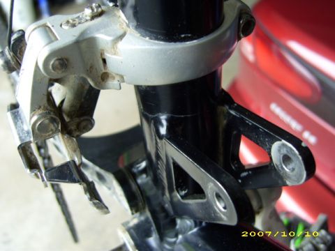 1972 Ford Ranchero - Detail of a bicycle's front derailleur mount, showing the bracket attached to the frame.