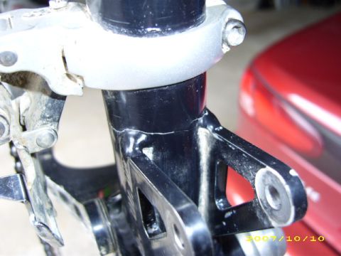 1972 Ford Ranchero - Detail of a bicycle frame, with a red vehicle partially visible in the background. The Supermotors.net logo is present in the lower right c…