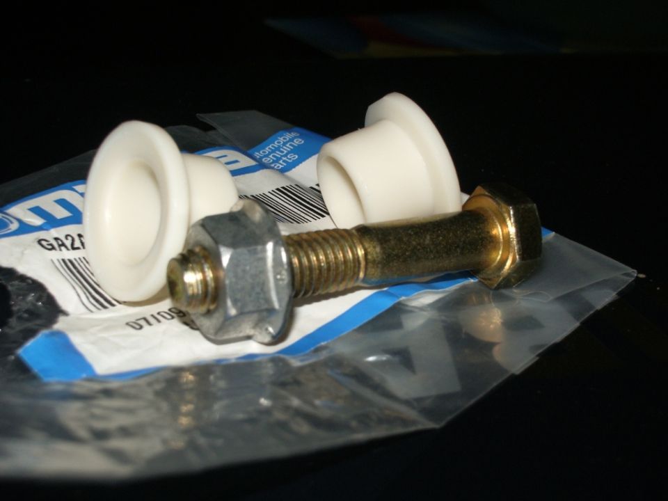Shift linkage bushings and bolt in packaging. Part number GA21 is visible