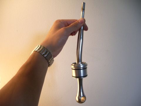 1995 Ford Probe - A short shifter is held in a person's hand against a plain background.