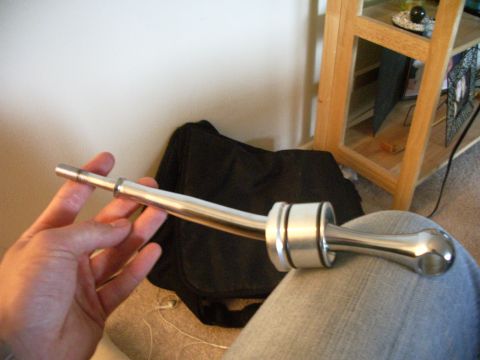 1995 Ford Probe - A person is holding a short shifter assembly, likely for a manual transmission vehicle.