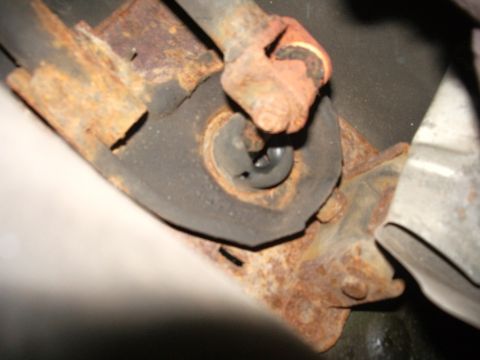1995 Ford Probe - Close-up of a rusted metal bracket and rubber bushing, with the Supermotors.net logo in the corner.