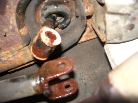 1995 Ford Probe - Close-up of corroded automotive linkage components, likely part of a shifter mechanism.
