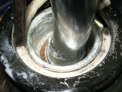 1995 Ford Probe - Detail of a shifter mechanism, likely part of a short shifter installation, with visible wear and lubricant.
