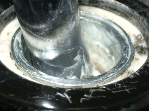1995 Ford Probe - A close-up view of a shifter lever assembly, likely part of a short shifter installation, showing the metal lever within its housing and wh…