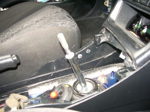 1995 Ford Probe - Interior view of a car's center console with the shifter mechanism disassembled.