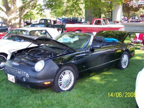 1972 Ford Ranchero - A black convertible is displayed with its hood open at an outdoor event with other vehicles present.