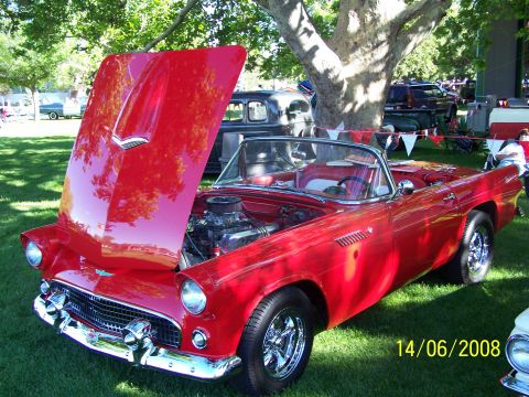 1972 Ford Ranchero - A red 1957 Ford Thunderbird convertible is displayed with its hood open at an outdoor event.