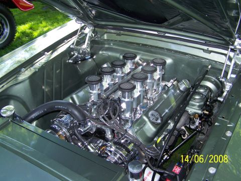 1972 Ford Ranchero - Close-up view of a V8 engine with multiple carburetors and chrome detailing.