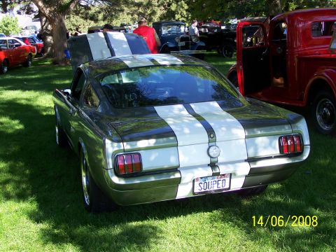1972 Ford Ranchero - Rear view of a 1965 Ford Mustang fastback with racing stripes at a car show.