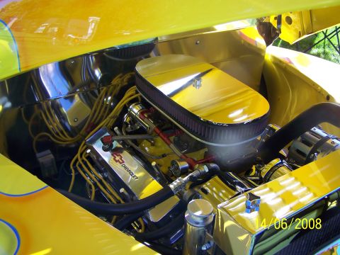1972 Ford Ranchero - Close-up of a custom yellow engine bay, showing a Chevrolet V8 engine with chrome accents.