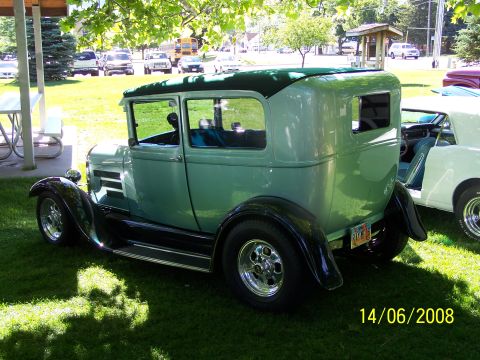 1972 Ford Ranchero - A mint green coupe with a black roof and fenders is parked on grass next to another vehicle.