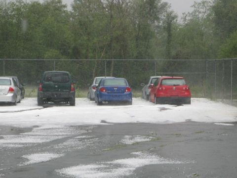 1971 Ford Ranchero - A parking lot is covered in a thick layer of hail, with several cars parked amidst the storm's aftermath.