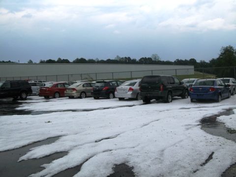 1971 Ford Ranchero - Hail covers the ground in a parking lot with multiple vehicles.
